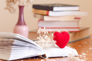 open book with heart and flowers